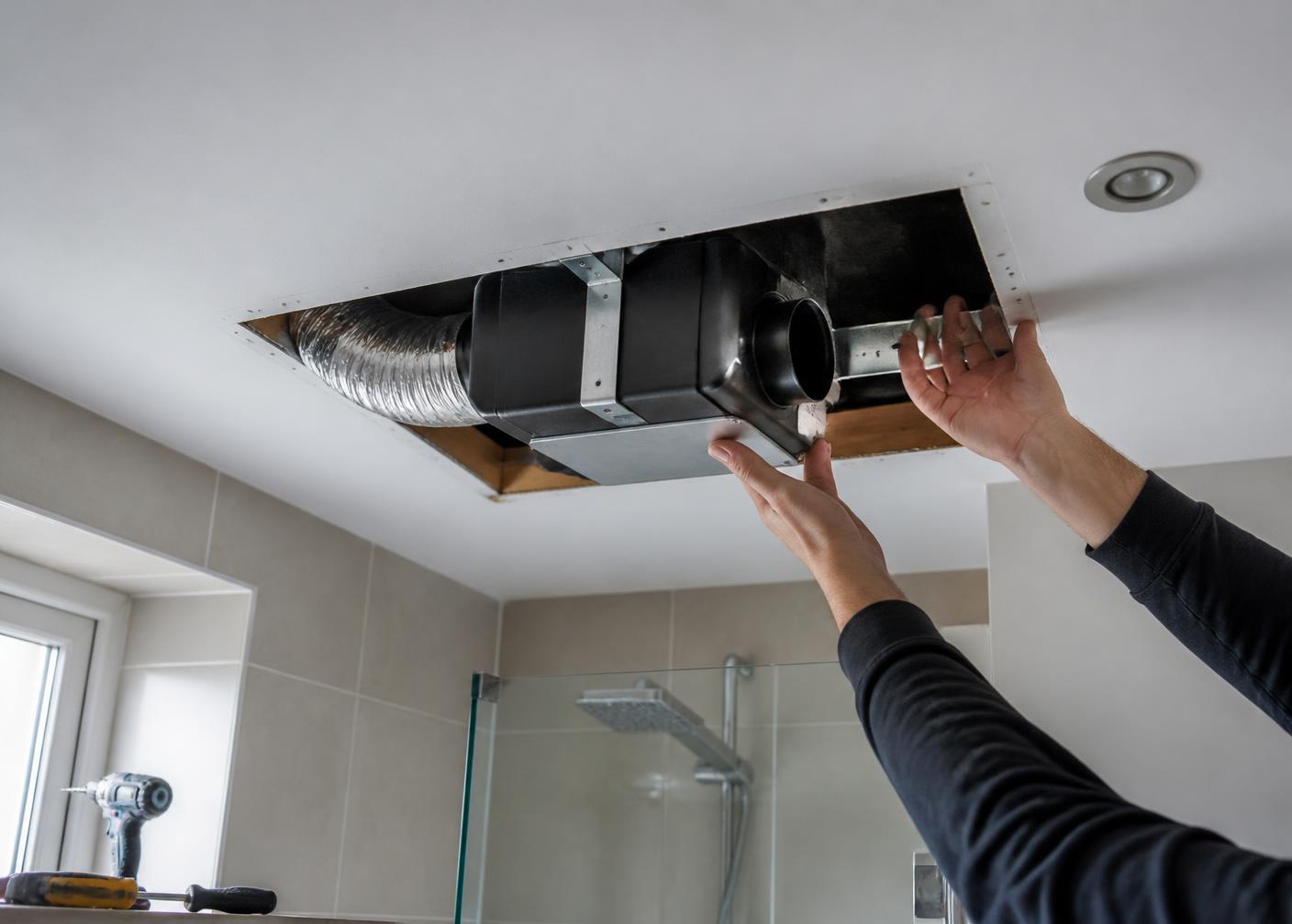 A modern continuous extract ventilation unit installed in a bathroom by Damp Solve